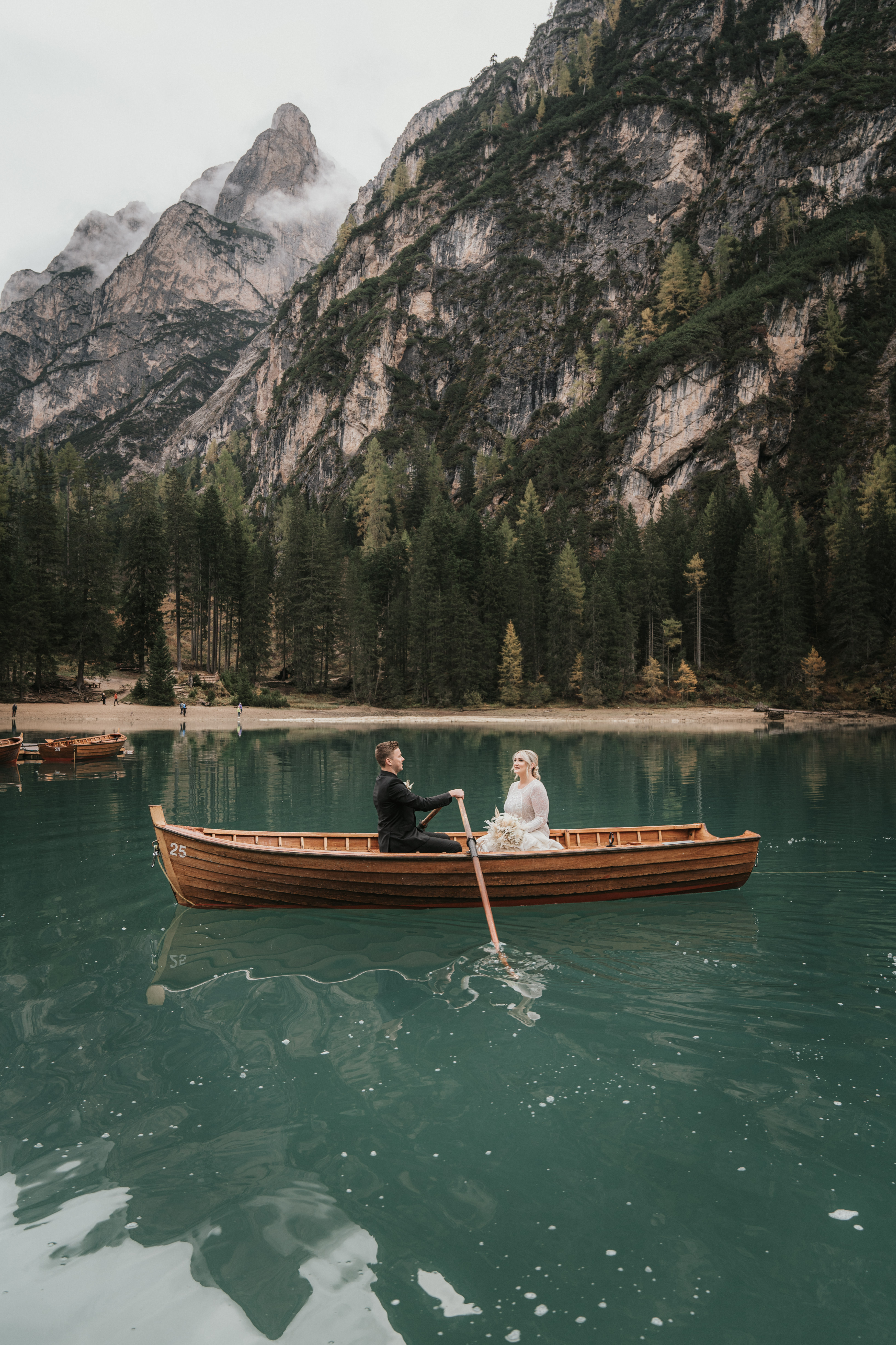 Couple exchanging vows on the wooden dock at Lago di Braies – intimate elopement ceremony with Dolomite reflection, Lago di Braies photographer