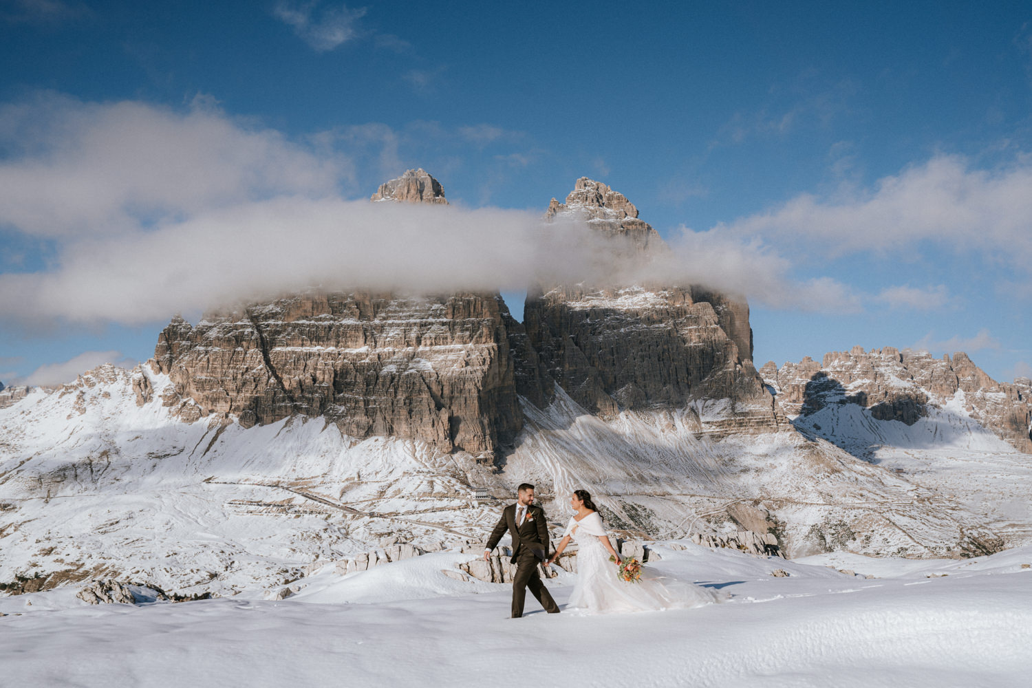  A couple celebrating their secret elopement in the Dolomites, surrounded by stunning mountain views.